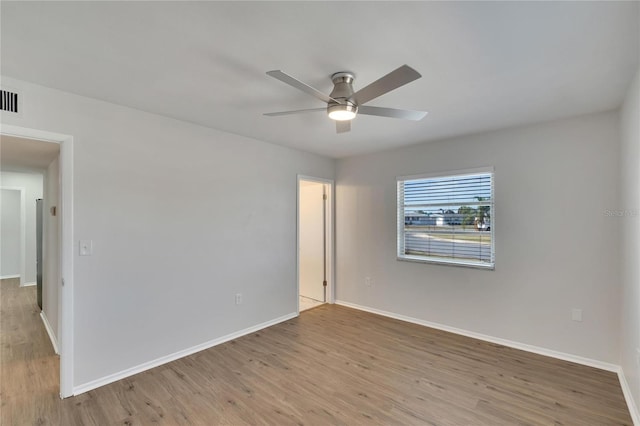 spare room with light hardwood / wood-style floors and ceiling fan