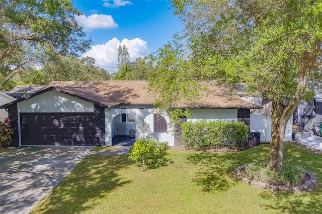 ranch-style home featuring a front lawn and a garage