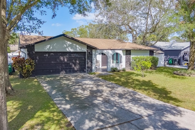 ranch-style house featuring a front lawn and a garage