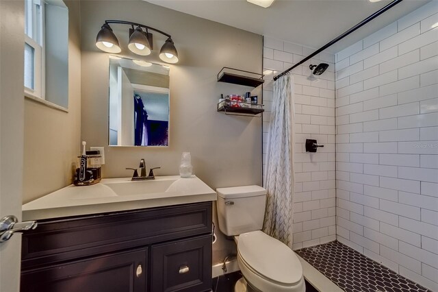 bathroom with vanity, toilet, and walk in shower