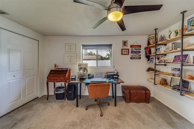 home office with light carpet, a textured ceiling, and ceiling fan