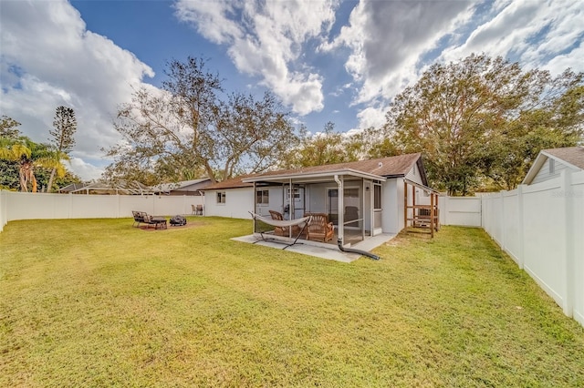 rear view of property with a yard and a patio area