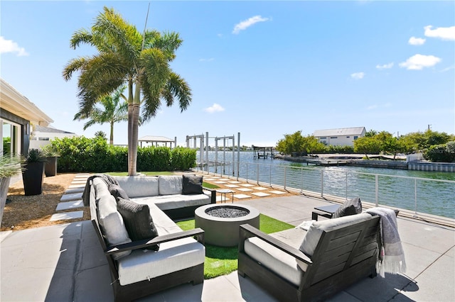 view of patio featuring an outdoor living space, a boat dock, and a water view