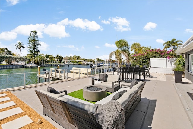 view of patio / terrace with an outdoor living space with a fire pit and a water view