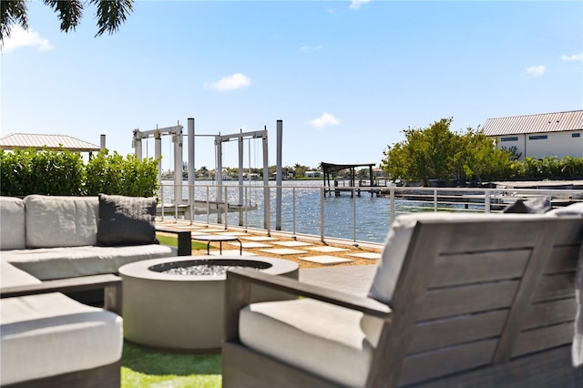 view of patio featuring an outdoor fire pit, a dock, and a water view