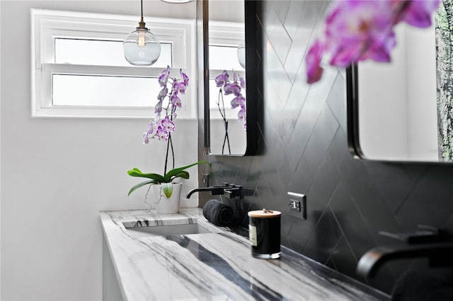 bathroom featuring backsplash and sink