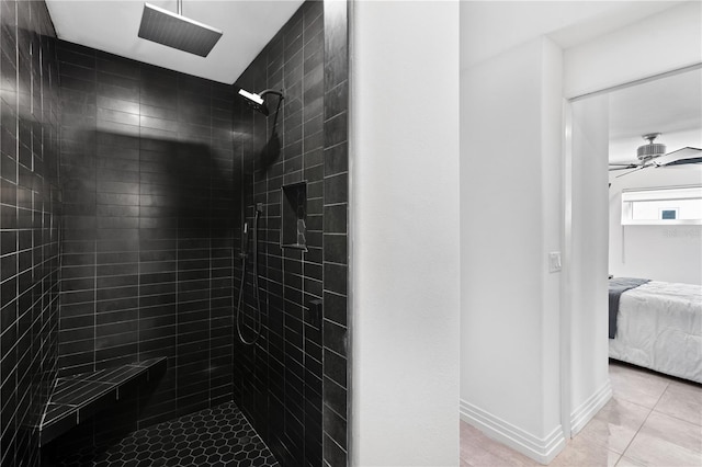 bathroom featuring ceiling fan, tile patterned floors, and tiled shower