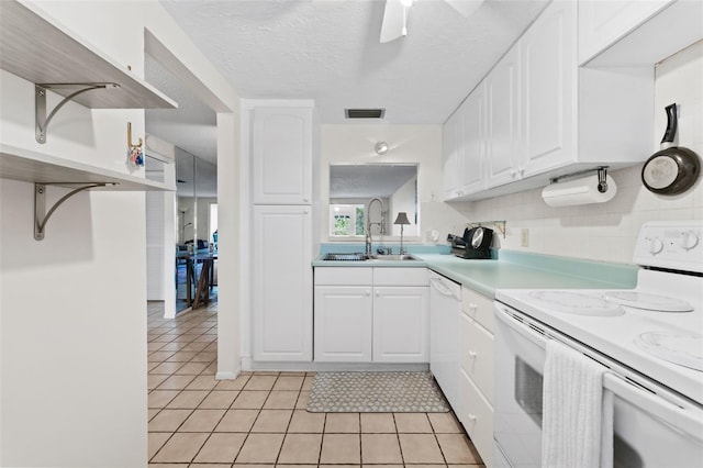 3361 Scorecard Dr Unit 0, New Port Richey, FL 34655 - kitchen with white appliances, a sink, white cabinets, light tile patterned flooring, and a textured ceiling