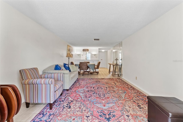 3361 Scorecard Dr Unit 0, New Port Richey, FL 34655 - living room featuring light tile patterned flooring and a textured ceiling