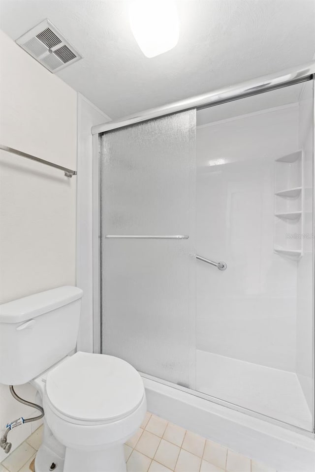 3361 Scorecard Dr Unit 0, New Port Richey, FL 34655 - bathroom with a shower stall, tile patterned flooring, and toilet