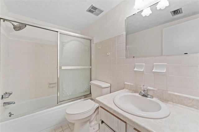 3361 Scorecard Dr Unit 0, New Port Richey, FL 34655 - full bath with toilet, vanity, shower / bath combination with glass door, tile walls, and tile patterned floors
