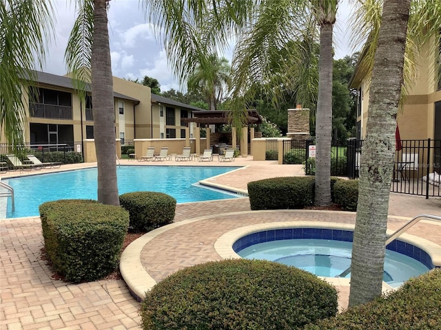 view of pool with a patio and a community hot tub