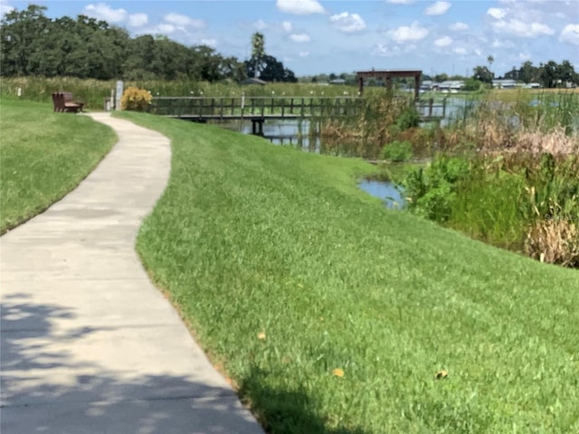 view of property's community featuring a water view and a yard