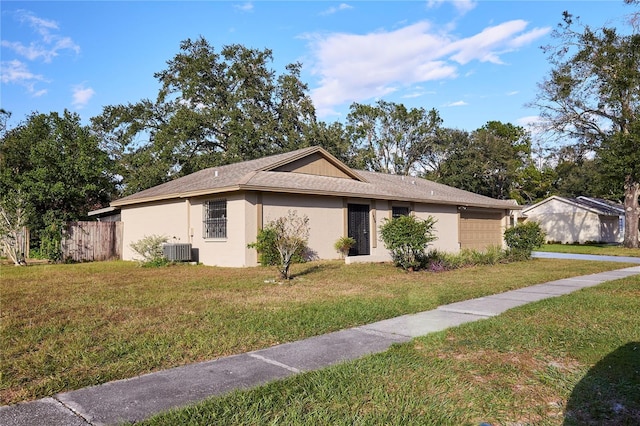 view of property exterior featuring central air condition unit, a lawn, and a garage