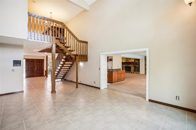 interior space featuring beamed ceiling, high vaulted ceiling, a chandelier, and light tile patterned floors