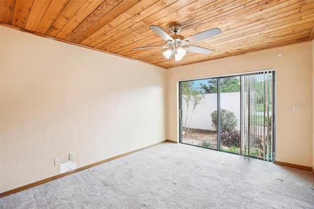 carpeted spare room with ceiling fan and wooden ceiling