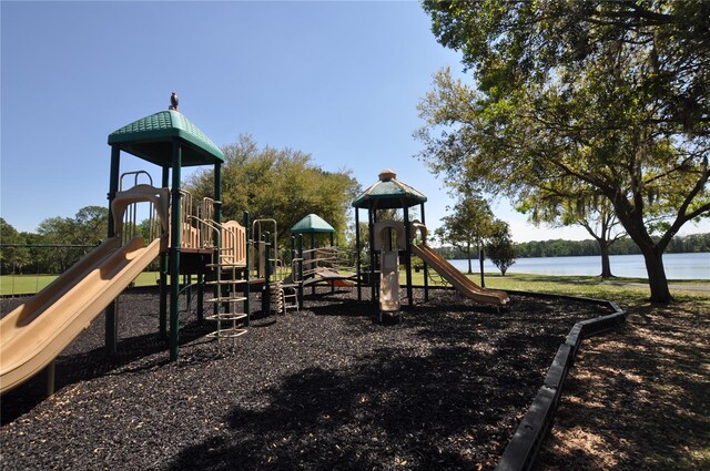 view of playground with a water view