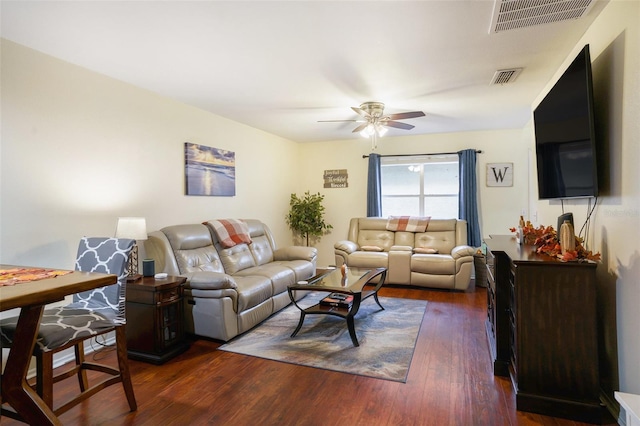 living room with dark hardwood / wood-style flooring and ceiling fan