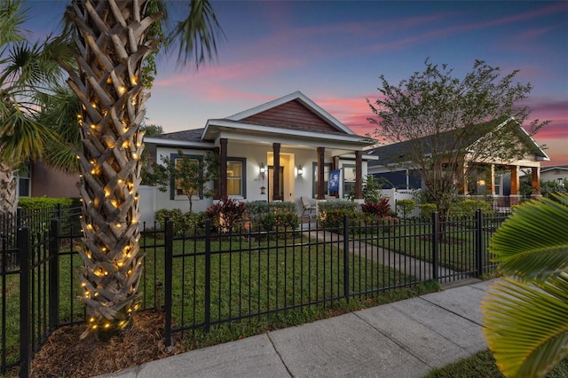 view of front of property with a lawn and covered porch