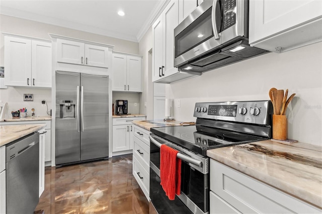 kitchen featuring light stone counters, white cabinetry, crown molding, and appliances with stainless steel finishes