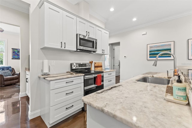 kitchen with sink, white cabinetry, stainless steel appliances, and ornamental molding