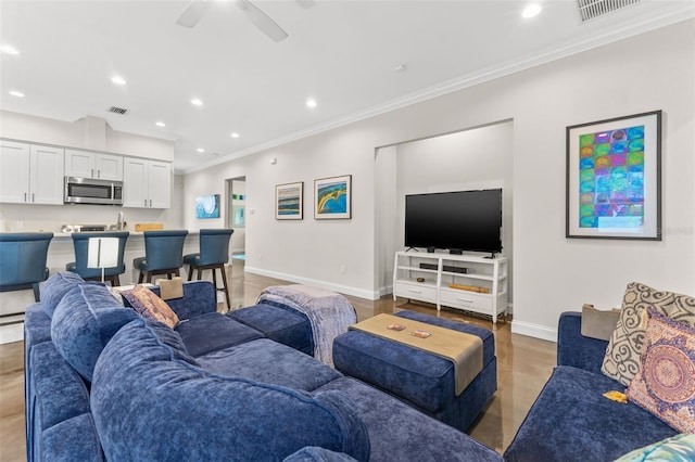 living room featuring ceiling fan and ornamental molding