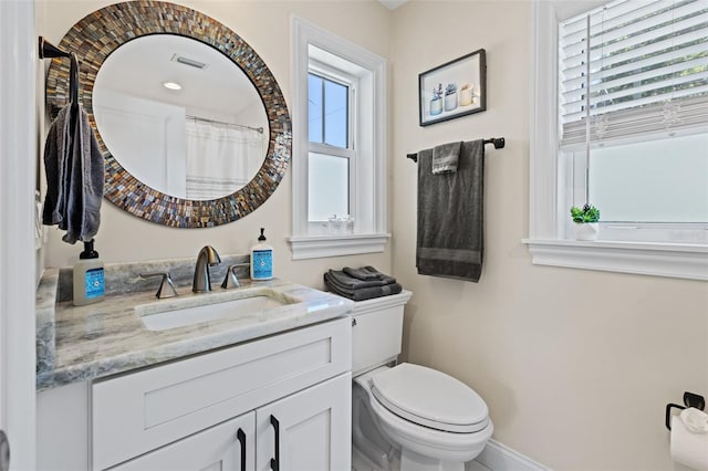 bathroom featuring vanity, a shower with shower curtain, and toilet