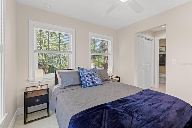 tiled bedroom featuring ceiling fan