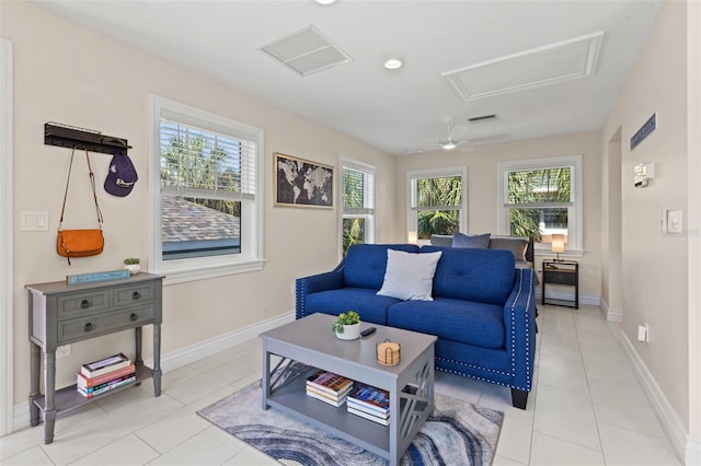 living room with ceiling fan, plenty of natural light, and light tile patterned floors