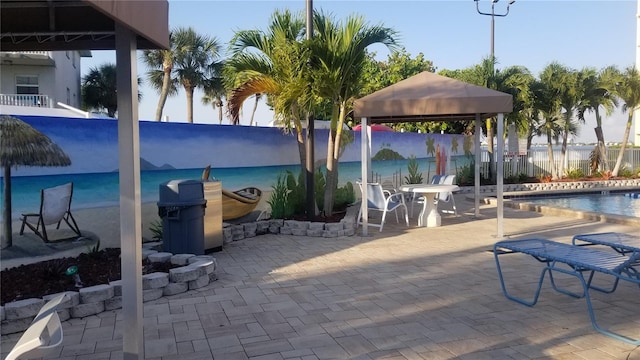 view of pool featuring a gazebo, fence, and a patio area