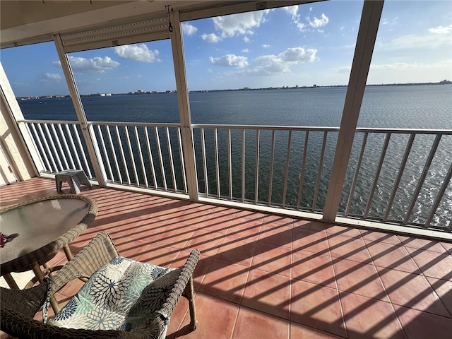 unfurnished sunroom with a water view