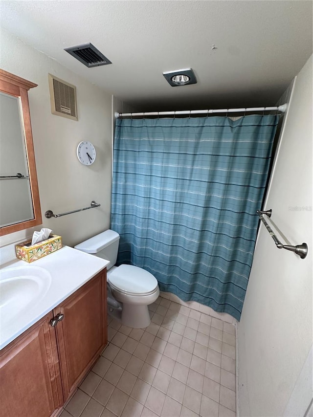 bathroom with vanity, curtained shower, toilet, and tile patterned floors