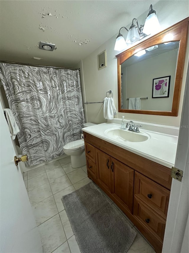 bathroom featuring vanity, toilet, tile patterned floors, and walk in shower