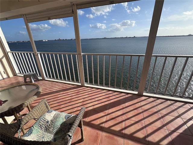 sunroom / solarium featuring a water view