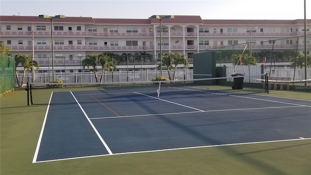 view of tennis court with fence