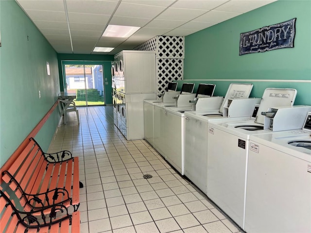 washroom featuring washing machine and clothes dryer, stacked washer and dryer, and light tile patterned floors