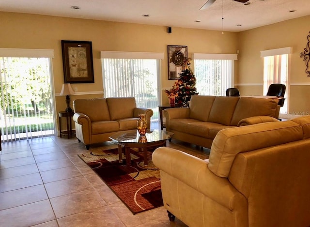 tiled living room with ceiling fan