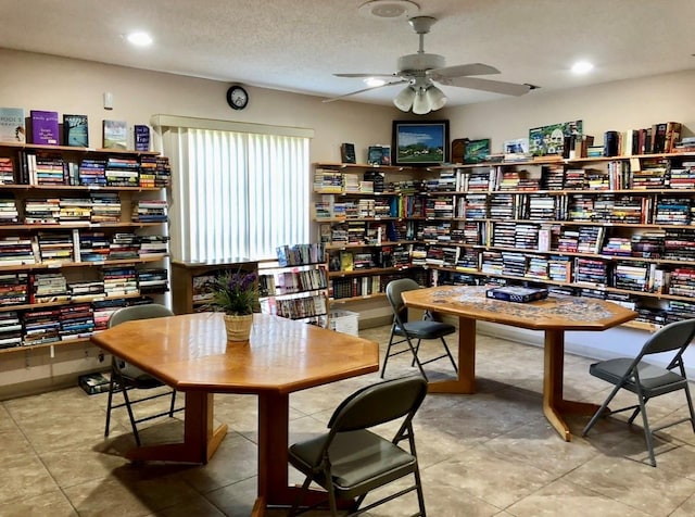 interior space featuring ceiling fan and a textured ceiling