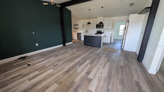 kitchen with visible vents, light countertops, white cabinetry, light wood-style flooring, and appliances with stainless steel finishes