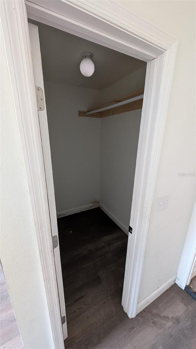 walk in closet with wood-type flooring