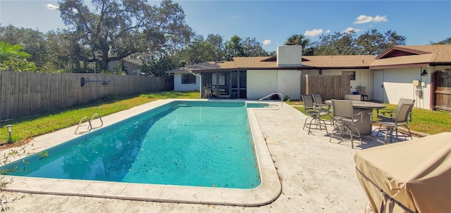 view of swimming pool with a patio