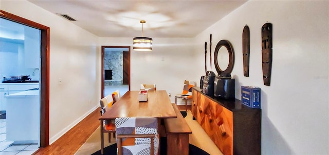 dining space with light wood-type flooring and sink