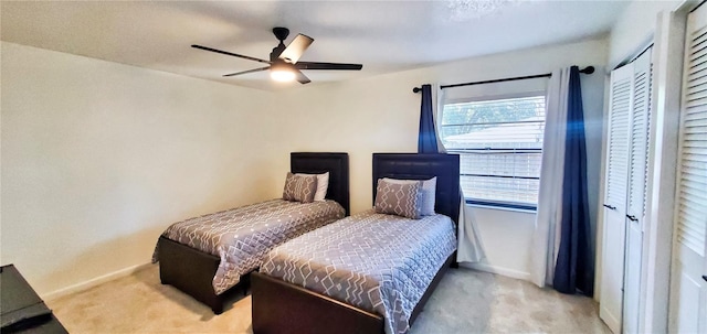 carpeted bedroom featuring ceiling fan and a closet