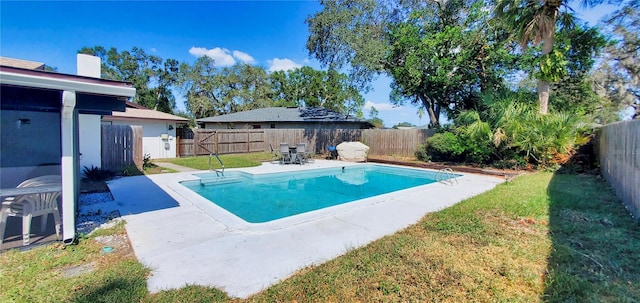 view of pool with a yard and a patio area