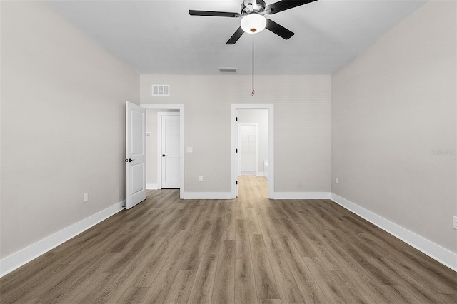 unfurnished bedroom featuring hardwood / wood-style flooring and ceiling fan