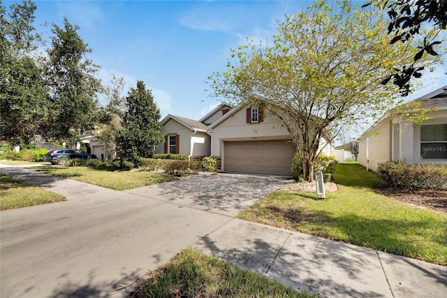 view of front of house with a front yard and a garage