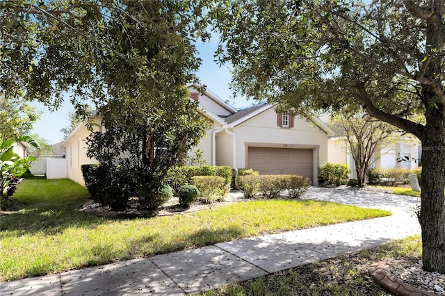 view of front facade featuring a garage and a front lawn