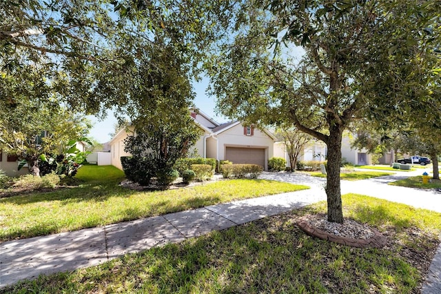 view of front of property featuring a front yard and a garage