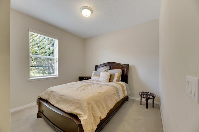 bedroom featuring light carpet