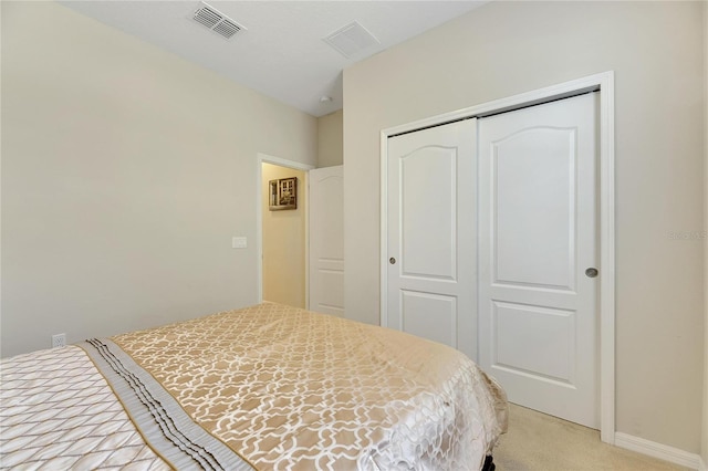 bedroom featuring light colored carpet and a closet